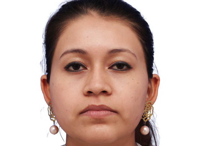 Close-up portrait of a woman facing the camera with a neutral expression, wearing gold earrings with pink pearls against a white background.