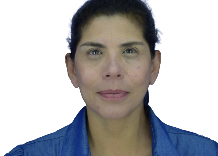 Head-and-shoulders portrait of a woman facing the camera, wearing a blue shirt against a white background.