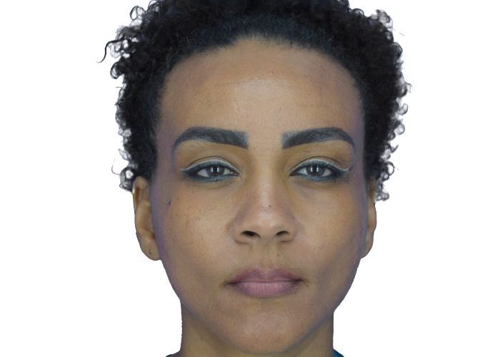 Woman with short curly hair and bold makeup: gold eyeshadow, blue eyeliner, and dark defined eyebrows, neutral expression.