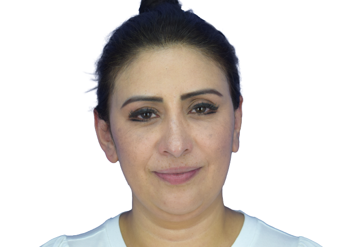 Close-up portrait of a woman with dark hair pulled back, wearing light makeup, and a neutral expression.